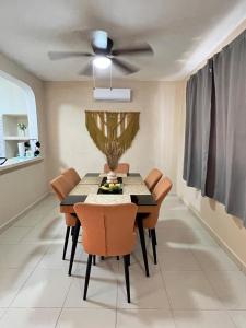 una sala da pranzo con tavolo e ventilatore a soffitto di Casa Colonos a Valladolid Altre 16 foto