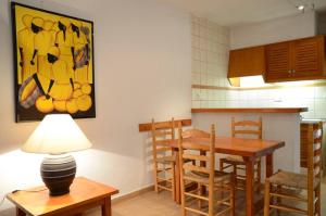 a kitchen with a table and a dining room at Costamar 13 in Es Pujols