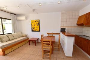 a living room with a couch and a table at Costamar 13 in Es Pujols