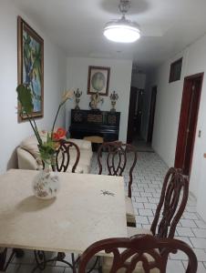 a table and chairs in a living room with a piano at Departamento el REPOSO in Guadalajara