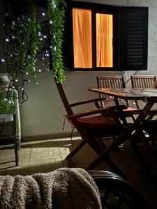 a table and chairs in a room with a table and a window at Casa do Campo in Carvoeiro +33 photos