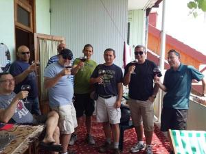 a group of men posing for a picture while drinking wine at Leli in Sighnaghi