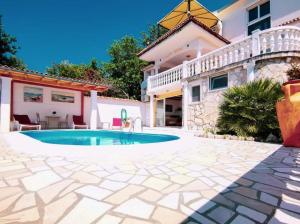 a swimming pool in front of a house at Villa Amarila in Podaca