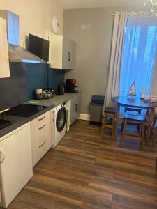 a kitchen with a table and a dining room at Appartement JOANNA in Vittel