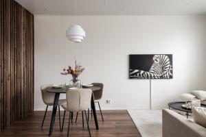 a dining room with a table and chairs at Borg Itsenäisyydenkatu, Centre Spacious 2-Room Apt, King Bed, Free Parking & Wifi in Pori