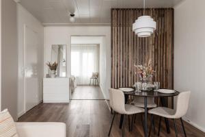 a dining room with a table and chairs at Borg Itsenäisyydenkatu, Centre Spacious 2-Room Apt, King Bed, Free Parking & Wifi in Pori +6 photos