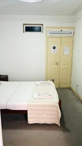 a hospital room with a bed and a door at São Lázaro Bhuiyan Family Host in Lisbon