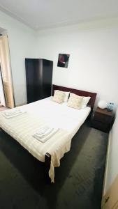 a bedroom with a large bed with white sheets at São Lázaro Bhuiyan Family Host in Lisbon
