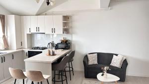 a kitchen with a counter and chairs in a room at DURU luxury property in Rădăuţi