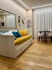 a bedroom with a couch with a table and a dining room at Palazzo dei Notai in Bologna