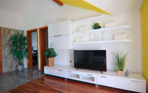 a living room with a flat screen tv on a wall at Schönes Ferienhaus mit Pool in Biograd na Moru