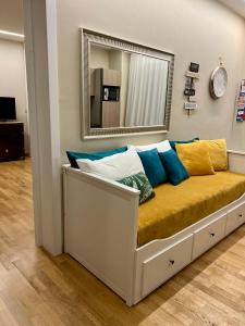 a couch with pillows on it in front of a mirror at Palazzo dei Notai in Bologna