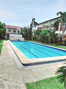 a large swimming pool in front of a building at Prestige quiet subdivision in Lapu Lapu City