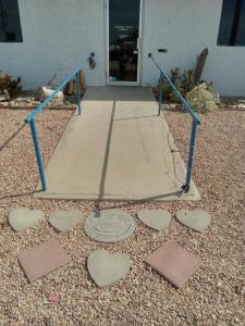 una struttura metallica con cuori per terra di fronte ad una porta di PATTYS Rv, 3 private sleeping g spaces, 1 shared a Quartzsite
