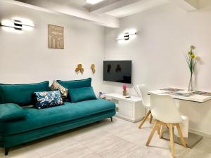 a living room with a green couch and a table at Mountain view in Bohinj in Bohinj