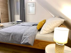 a bedroom with a bed with a blue comforter and pillows at Mountain view in Bohinj in Bohinj