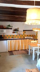a kitchen with a table and a counter top at Casa Juanillo in Miller +11 photos