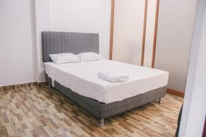 ein Bett mit zwei Kissen darauf in einem Zimmer in der Unterkunft Charm & Confort - Tarapoto - Peru in Tarapoto