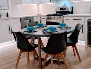 a kitchen with a table with four chairs and a stove at Custom Design Kitchen King Beds Laundry Large TVs in Rome