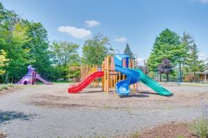 a playground with two slides and a play structure at Deer Chalet in the heart of Pocono in Tobyhanna