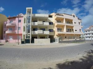 a building on the side of a street at Surf House Cabo Verde in Santa Maria