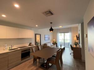 a kitchen and living room with a table and chairs at Splendid apartment for 4 pax partial view of the beach in Hollywood M in Hollywood