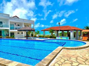 a swimming pool in front of a building at Cobertura Encantadora Conde PB in Conde