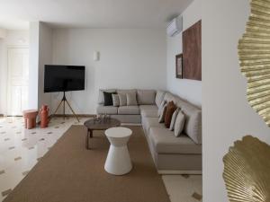 Una sala de estar con un sofá y un televisor. en Holiday home with a private pool in Elounda, en Elounda