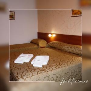 Postel nebo postele na pokoji v ubytování IRUPÉ APART HOTEL