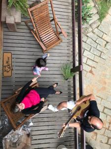 a group of three people laying on the floor at Chalé Duzé Itaipava in Itaipava +61 photos