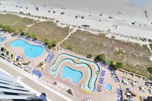 an aerial view of a water park next to the beach at Oceanfront TOP LOCATION MODERN RESORT Lazy River Huge Pool Oasis in Myrtle Beach
