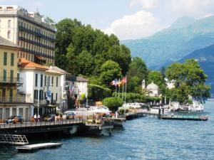 a view of a river with buildings and a dock at Holiday Home by the Beach in Sala Comacina