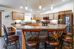 a kitchen with a large island with bar stools at Family-Friendly Fairbanks Home Chena River Access in Fairbanks