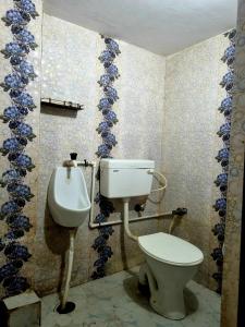 a bathroom with a toilet and a sink at Mishra villa in Prayagraj