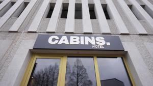 a building with a sign on top of it at Cabins Hotel Amsterdam in Amsterdam
