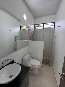 a bathroom with a toilet and a sink and a shower at Casa de campo D&G in Carmen de Apicalá +12 photos