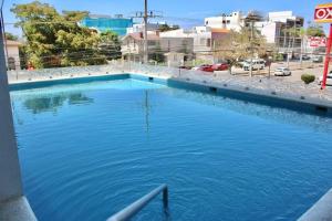 a large pool of blue water next to a street at Departamento Torre Iberika Cercas Del Malecon in Mazatlán