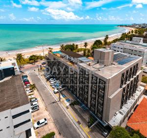 an aerial view of a building next to the beach at Arpoar Suítes by Day by Day in João Pessoa