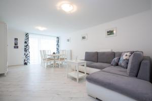 a living room with a couch and a table at Apartments Grom in Bled