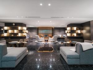 a living room with two couches and a table at Paradox Vancouver in Vancouver