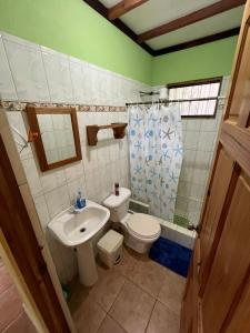 a bathroom with a toilet and a sink at Costa Rica Getaway in Jacó