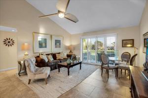 a living room with a couch and a table at PD Resorter 2BR with Golf course views in Palm Desert