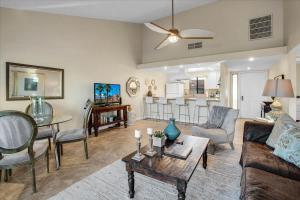 a living room with a couch and a table at PD Resorter 2BR with Golf course views in Palm Desert