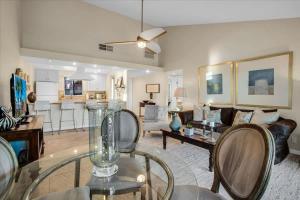 a living room with a glass table and a couch at PD Resorter 2BR with Golf course views in Palm Desert +49 photos