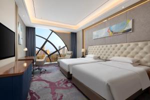 Una habitación de hotel con dos camas y una gran ventana. en Ramada by Wyndham Zhumadian West Station, en Zhumadian