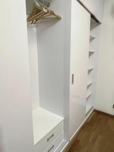 a walk in closet with white walls and shelves at No̱410 City View Apartment & free parking in Krakow +12 photos