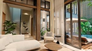 a living room with a white couch and a table at The One Boutique Villa & Spa Seminyak in Seminyak