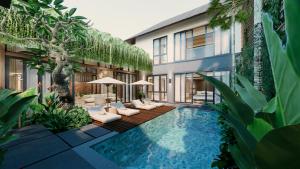 a swimming pool with lounge chairs and a building at The One Boutique Villa & Spa Seminyak in Seminyak
