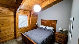 a bedroom with a bed and a window in a cabin at Coalition Lodge in Park City