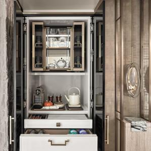 a kitchen with an open cabinet filled with food at Marina Bay Sands in Singapore